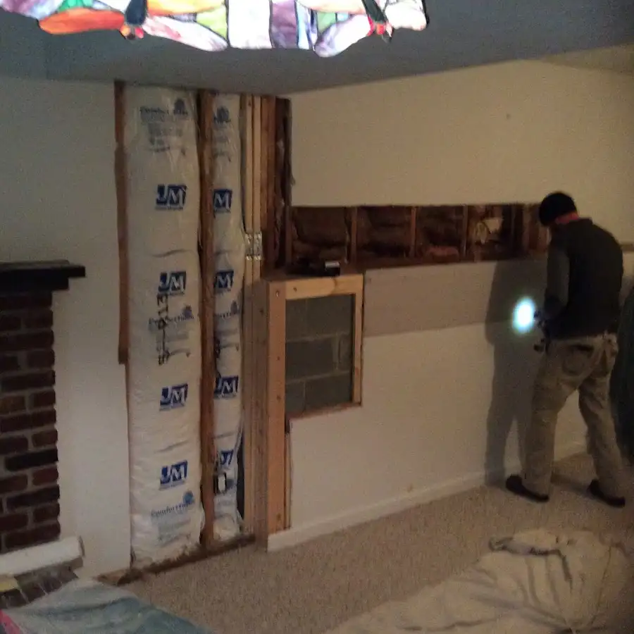 Restoration technician inspecting water damage in Rayne